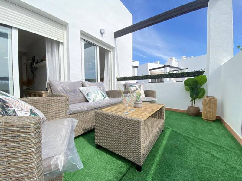 A terrace with comfortable seating and a table in a 3-room apartment.