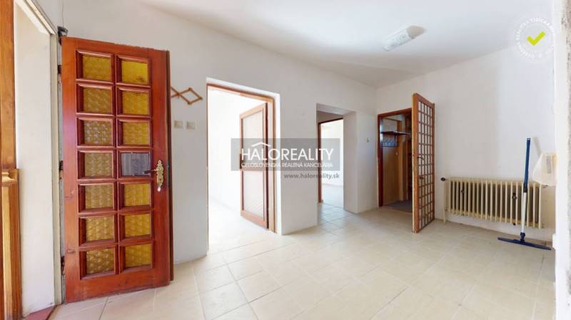 Entrance hall with a door and a radiator in a family house.