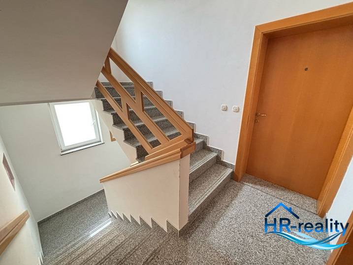 Staircase with wooden railing in a 3-room apartment, hr-reality, high-quality execution.