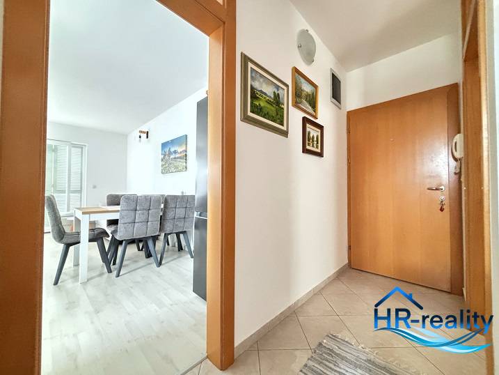 Interior of a 3-room apartment with a dining area and entrance hallway.