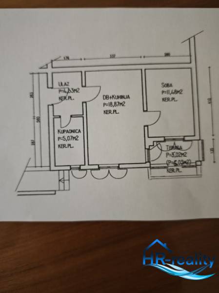 Floor plan of a 2-room apartment with a kitchen, room, bathroom, and terrace.
