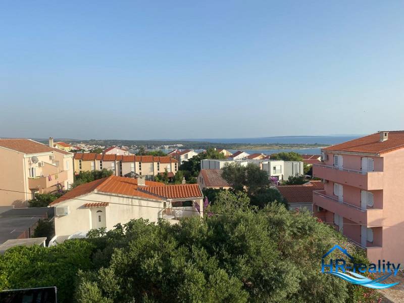 View from a 2-room apartment in Novalja of the sea and surrounding rooftops.