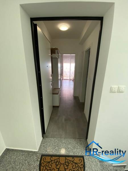 Entrance hallway of a 2-room apartment, with tiles and lighting.