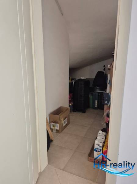 Storage space in a 2-room apartment with a slightly sloped ceiling, suitable for storage.