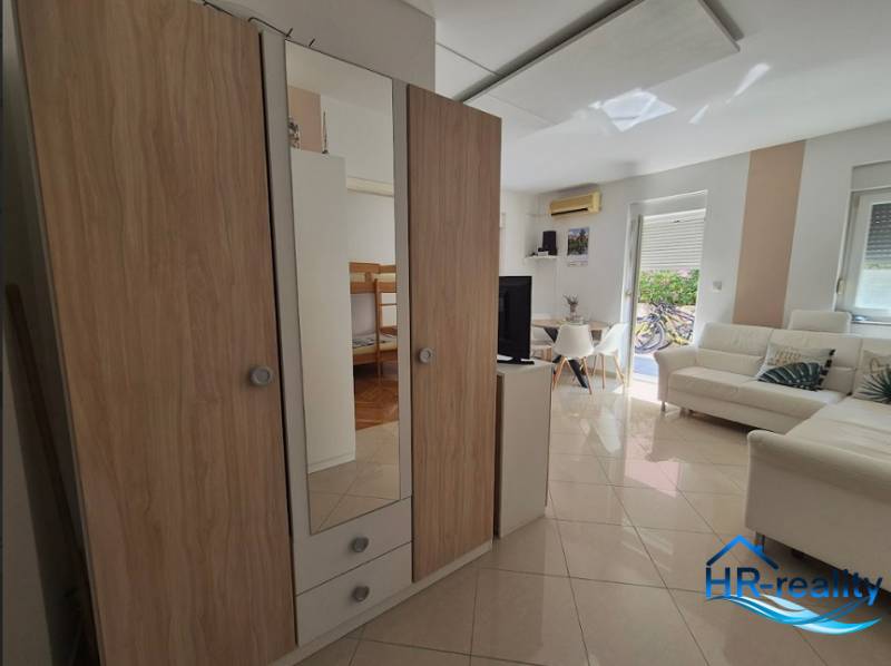 Interior of a 2-room apartment with a living room, wardrobes, and bright light.