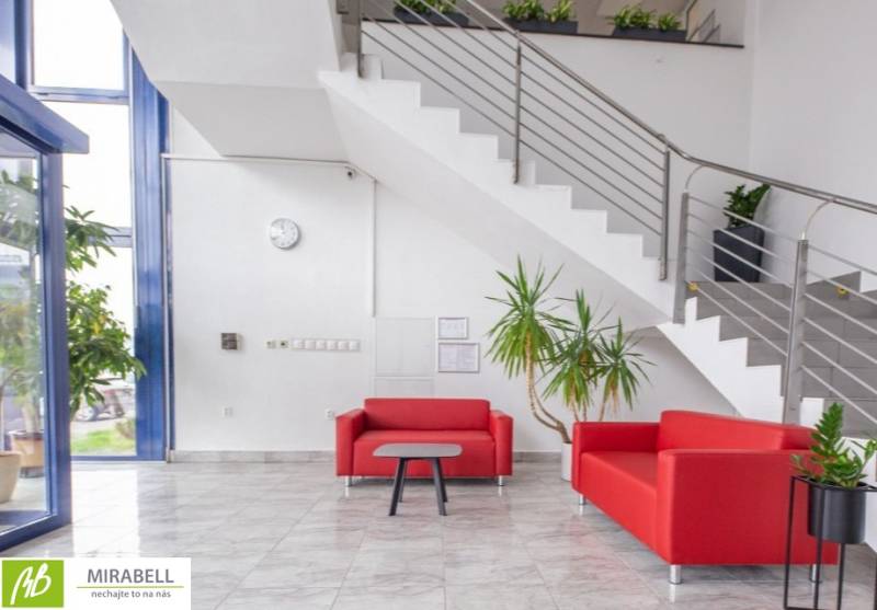 Offices with red sofas, plants, and stairs create a pleasant atmosphere for visitors.