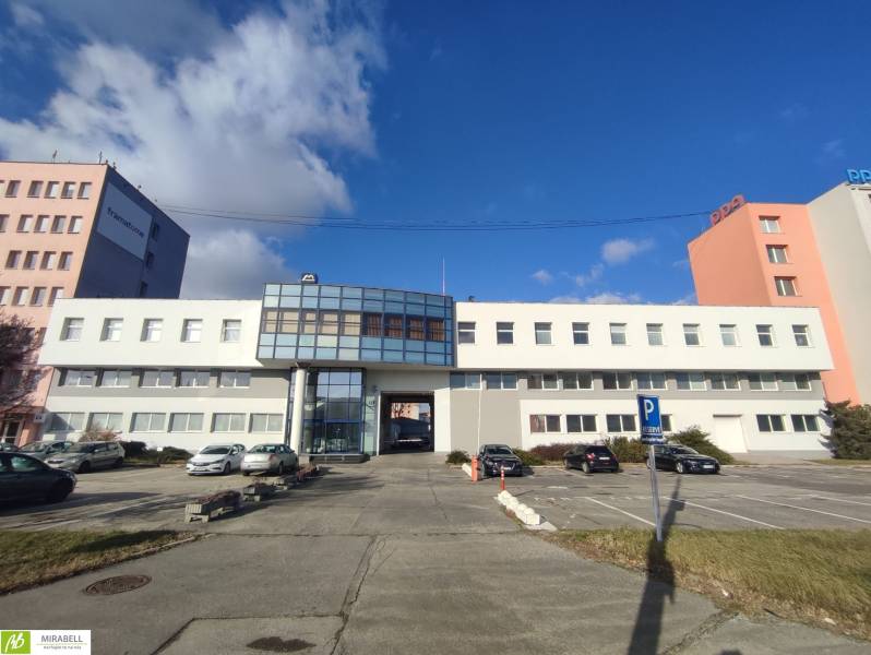 Offices on Vajnorská Street, Bratislava - Nové Mesto, with a parking area and cars.