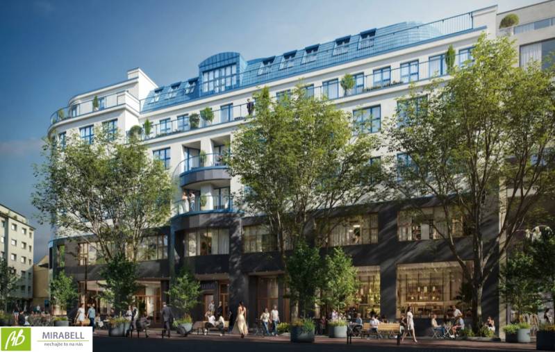 A building with commercial spaces surrounded by trees in Bratislava - Old Town on Poštová Street.