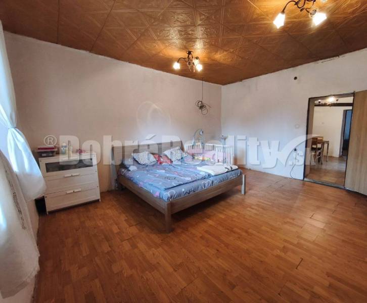 Bedroom in a family house with wooden flooring and a double bed.