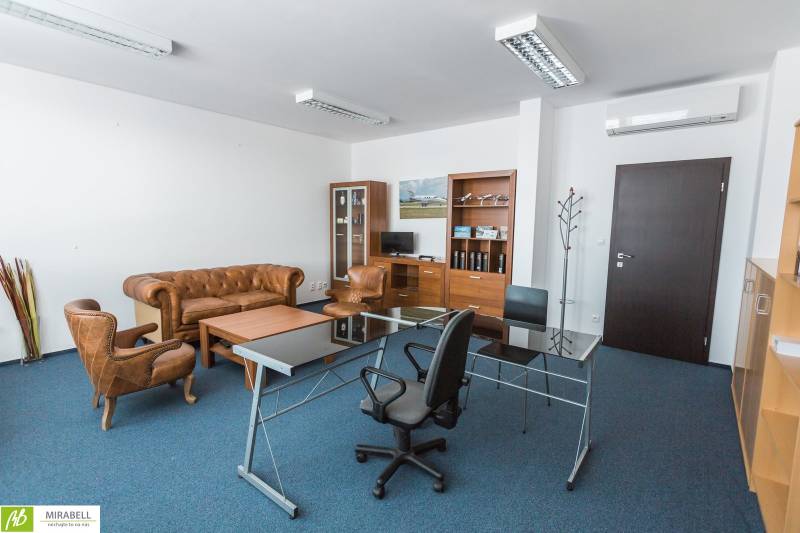 A stylish office interior with antique leather furniture and a glass table.