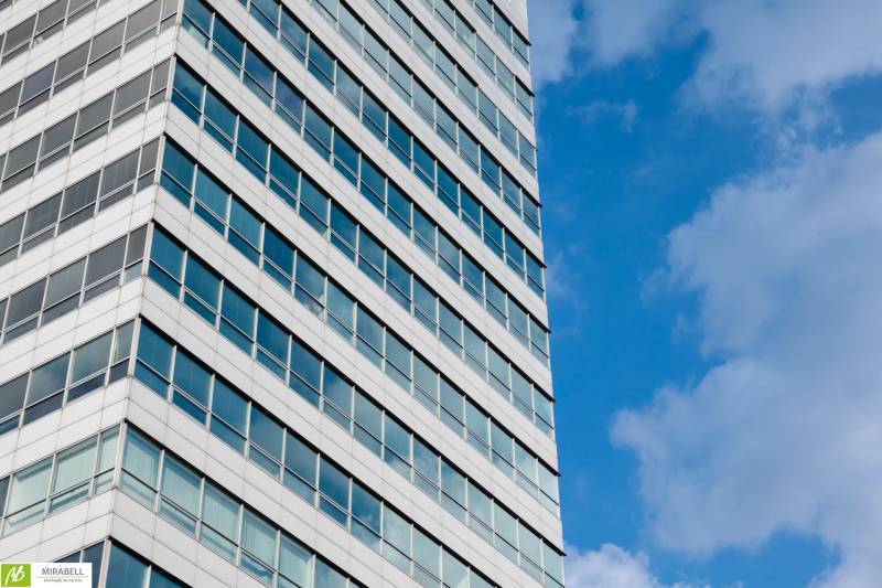 Building with glass windows and blue sky, Bratislava - Karlova Ves, Dúbravská cesta, offices.