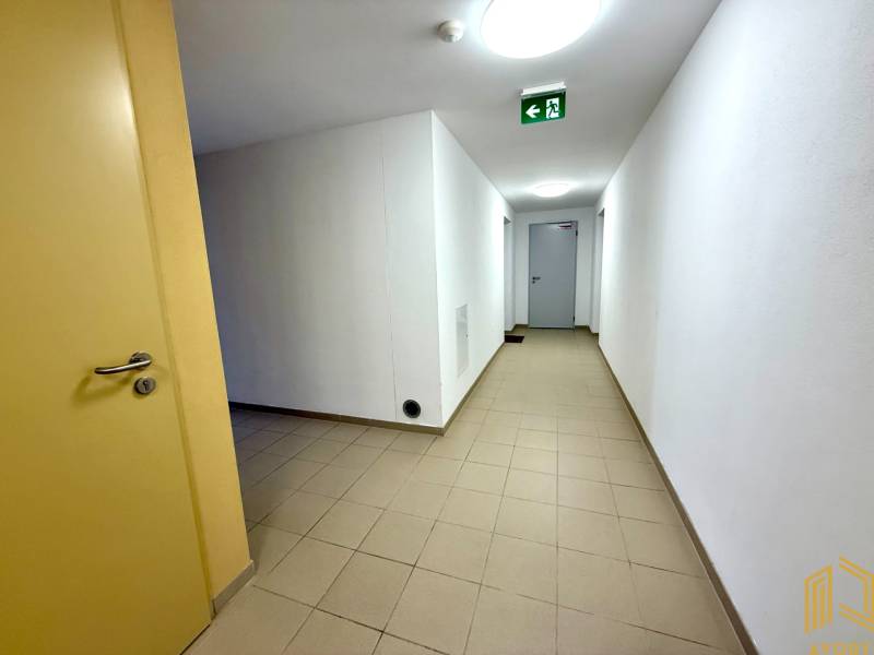A beige hallway with light walls in a 2-room apartment, doors on the left.