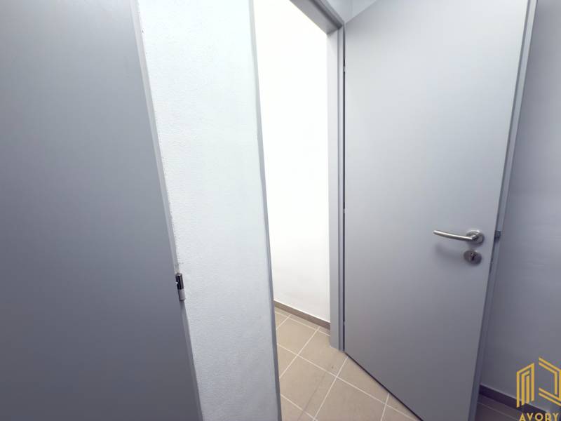 Opening white doors in the hallway of a 2-room apartment with tiles.
