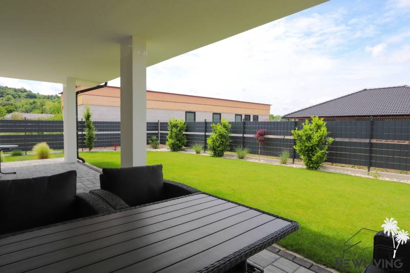 The terrace of a family house in Piešťany, with a view of the well-maintained garden and surrounding architecture.