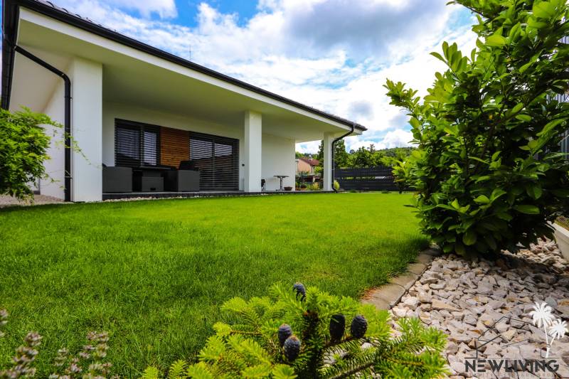 A family house in Piešťany with a green lawn, terrace, and landscaped garden.