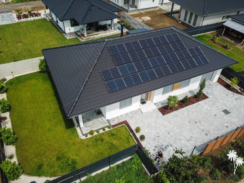 A family house in Piešťany with solar panels on the roof and a landscaped garden.