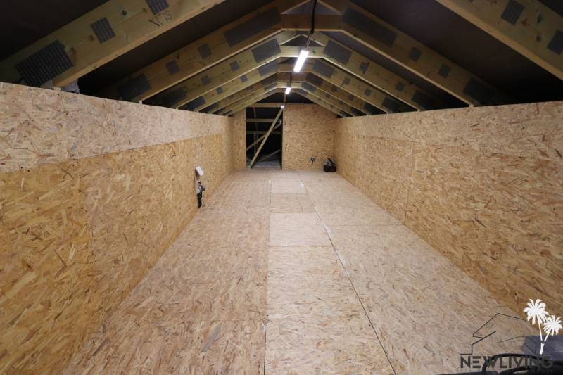 The attic of a family house with wooden panels and visible structure.