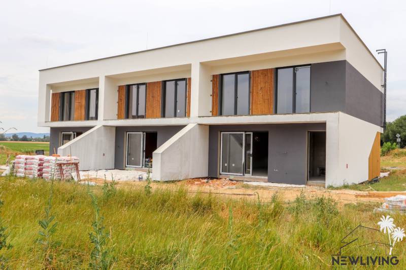 A newly built family house in Piešťany with a garden and large windows.