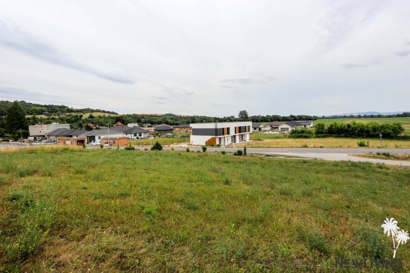 A family house in Piešťany surrounded by greenery, rural landscape, and neighboring houses.