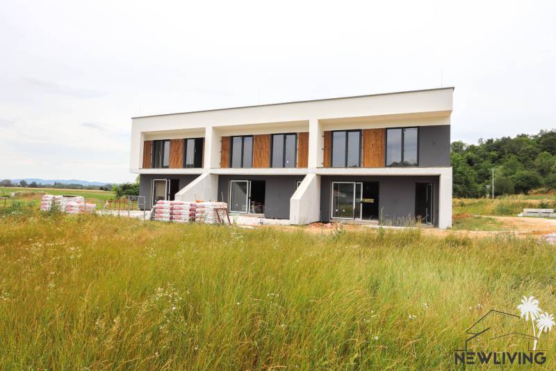 A family house in Piešťany with large windows in a natural environment.