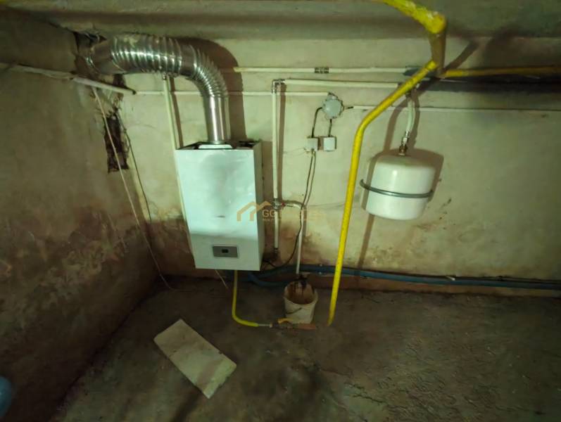 Gas boiler and piping in the basement of the family house.