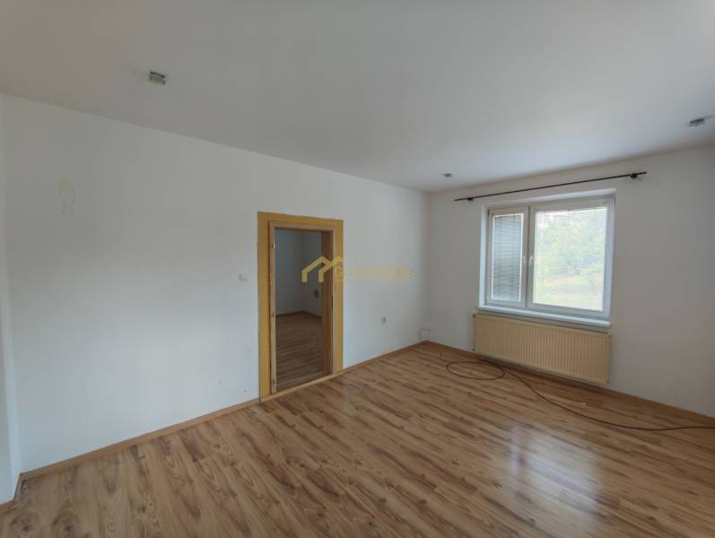 Transition room with wooden floor and window in a family house.