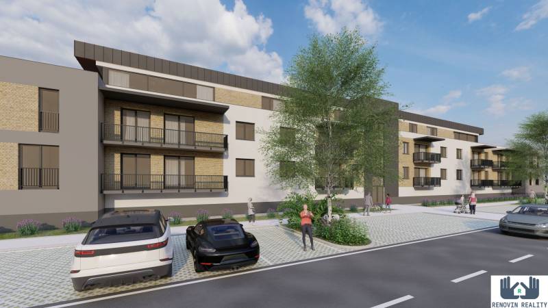 Construction of apartments in Kriváň with cars and people on the street near the apartment building.