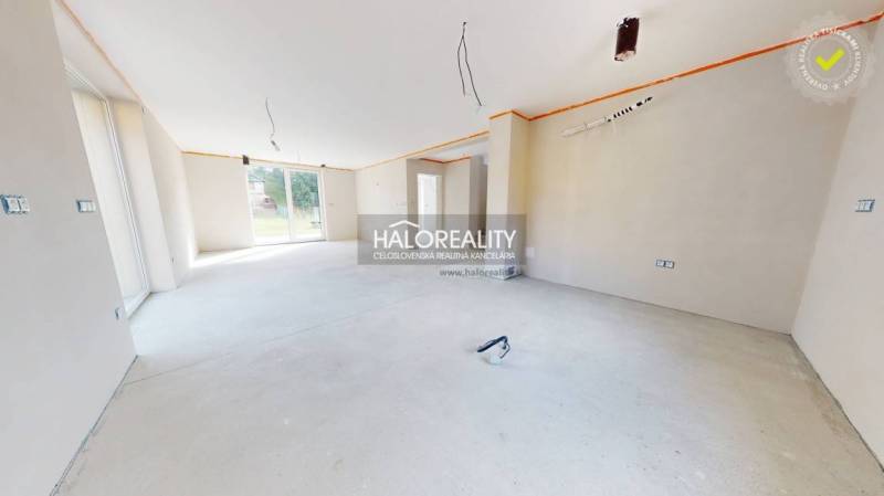 Spacious interior in a family house with large windows and preparation for electrical installations.