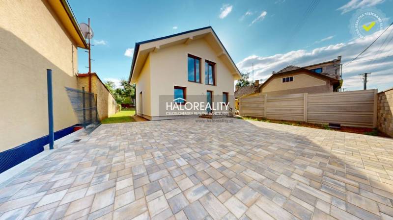 A family house in Rimavská Sobota with a paved yard and lawn on a spacious plot.
