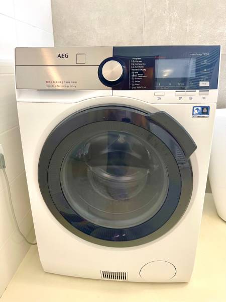 AEG washing machine with multiple programs in a 2-room apartment.