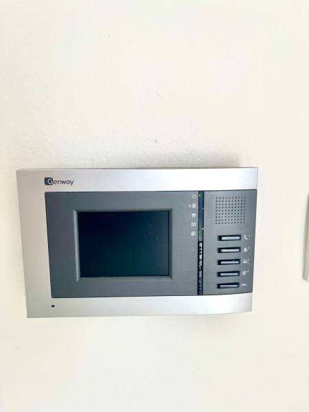 Interior control panel in a 2-room apartment with a touch screen and control buttons.