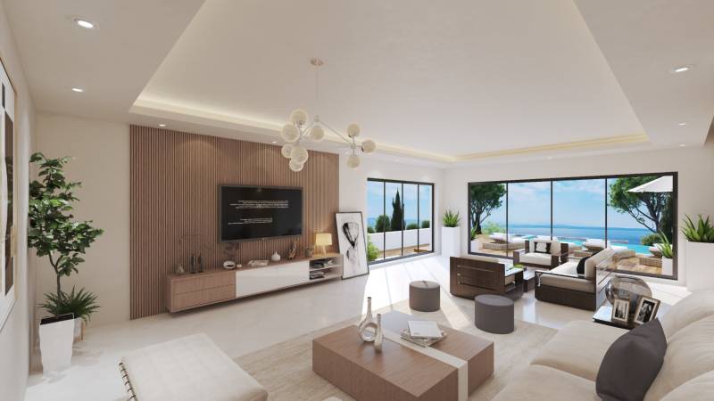 Living room in a villa with ocean view, large windows, and comfortable seating.