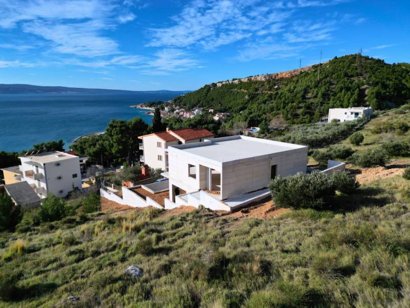 Villa in Duće with a view of the sea and surrounding hills.
