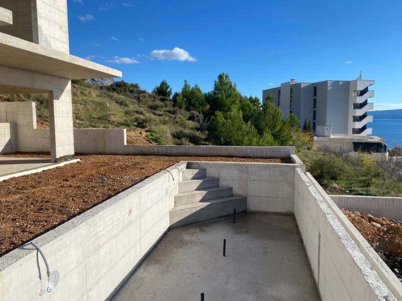 View from the villa in Duće with an unfinished terrace and a sea view.