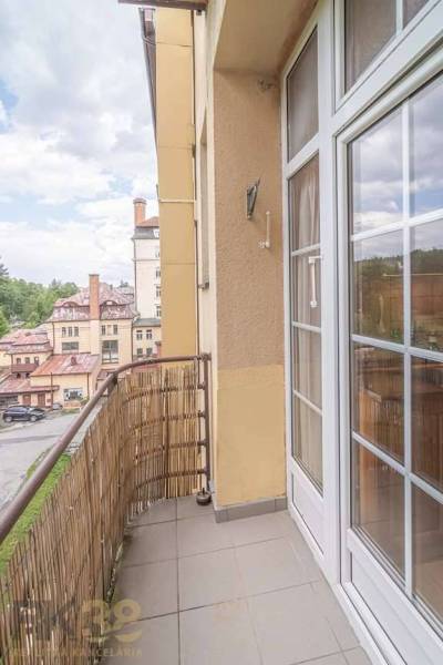 The balcony of a 3-room apartment in the High Tatras with a view of historic buildings.