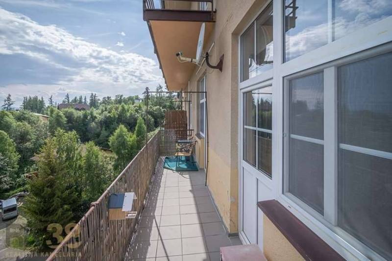 The balcony of a 3-room apartment in the High Tatras with a view of greenery and the sky.