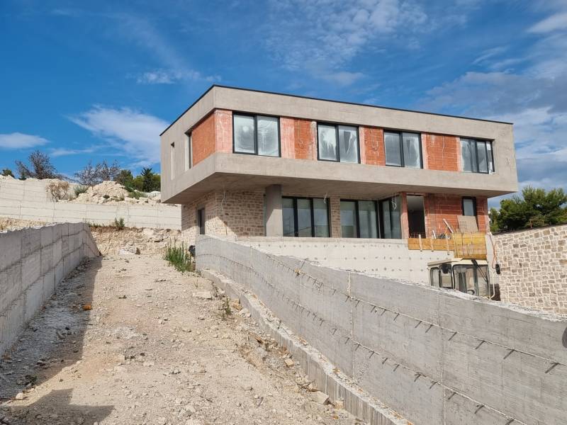 An unfinished villa in Vodice with a concrete terrace and modern windows.
