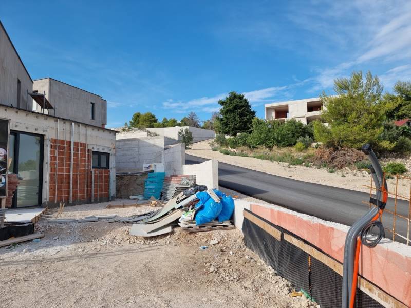 Building area at the villa in Vodice with a road and surrounding greenery.