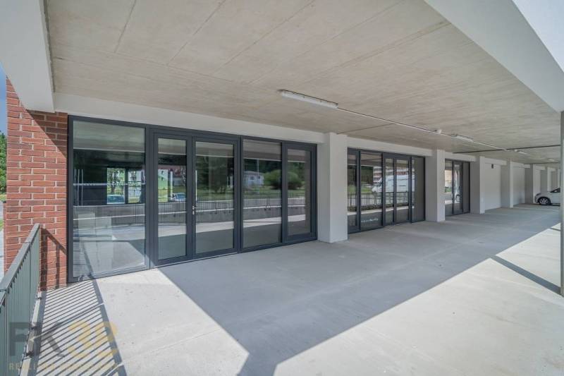 Commercial premises in the town of Svit with a glass entrance and a concrete ceiling.