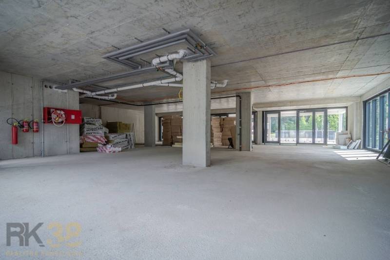 Commercial premises under renovation with glass and concrete, ready for modifications.