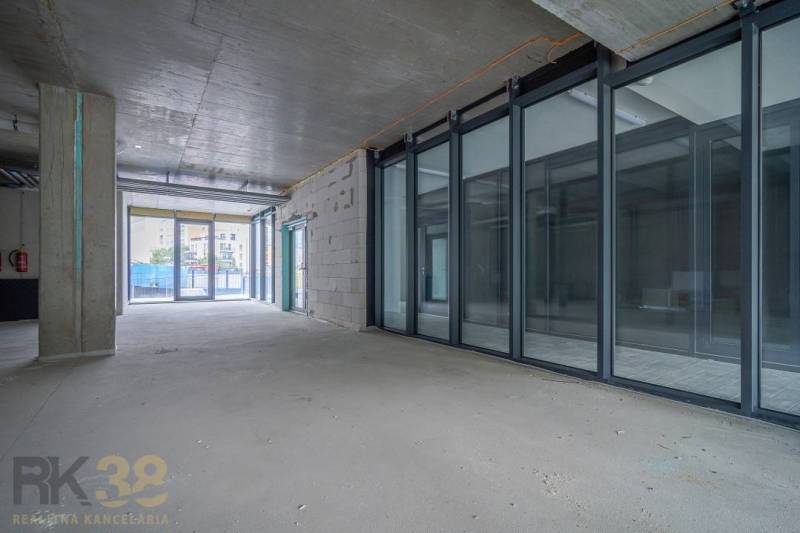 Spacious commercial spaces with large glass walls and views outside.