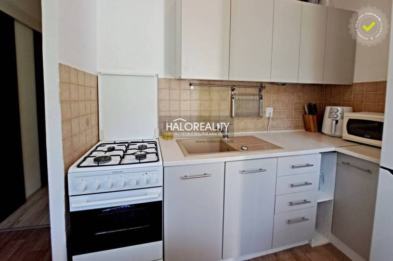 Kitchen in a 3-room apartment with a stove and a sink.