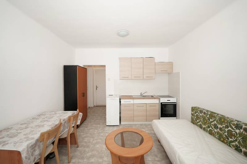 Offices with a kitchenette, dining table, sofa, and wardrobe.