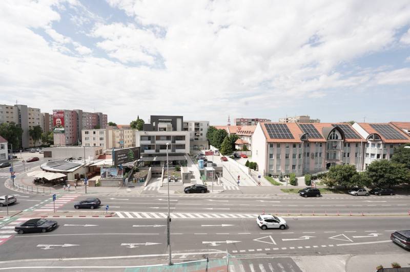 Traffic and buildings on Main Street in Dunajská Streda, office space.