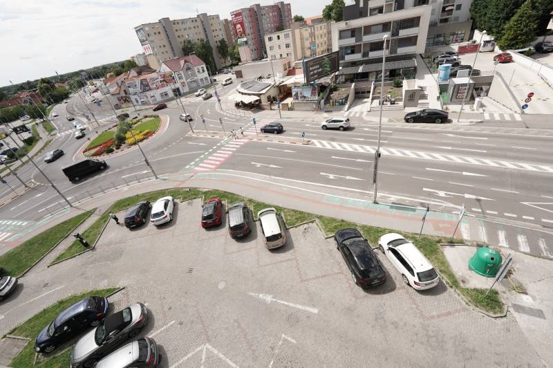 Roundabout on Hlavná Street in Dunajská Streda, surrounded by apartment buildings and a parking lot.