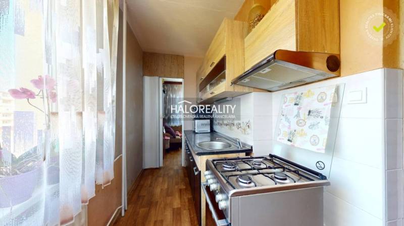 Kitchen in a 2-room apartment with a stove and kitchen unit.