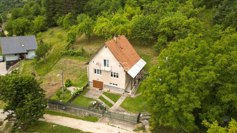 A family house in Papradno with a large garden and green surroundings.
