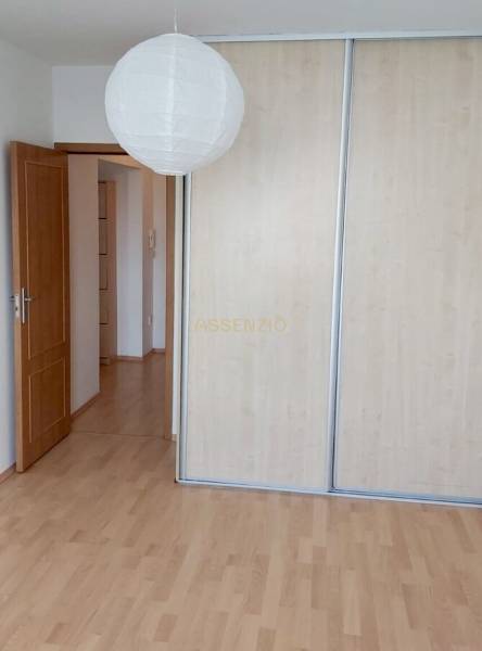 A room in a 3-room apartment with wooden floors and a wardrobe with sliding doors.