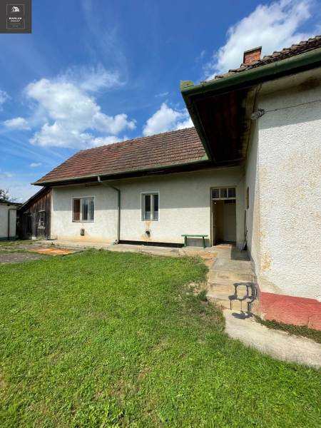 A family house in Trenčianske Stankovce with a lawn and a traditional roof under a blue sky.