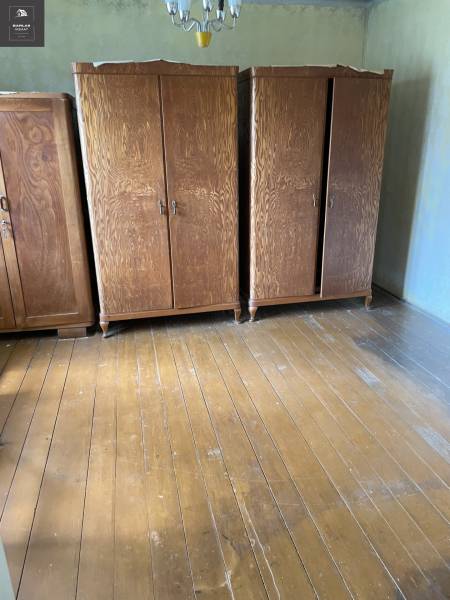 Wooden cabinets on a wooden floor in a room of a family house.